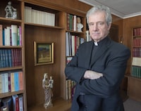 Archbishop Christian Lépine is seen in his office Wednesday, March 27, 2019, in Montreal. The Roman Catholic Archbishop of Montreal has filed a legal challenge to Quebec's end-of-life legislation, arguing it violates religious freedom. THE CANADIAN PRESS/Ryan Remiorz