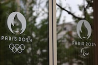 FILE PHOTO: The logo of the Paris 2024 Olympics and Paralympics Games and the Olympics rings are pictured on the Pulse building, the headquarters of the Paris 2024 Olympics organizing committee, as a police search is currently underway, in Saint-Denis near Paris, France, June 20, 2023. REUTERS/Stephanie Lecocq/File Photo