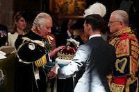 Britain's King Charles III is presented with the Crown of Scotland during the National Service of Thanksgiving and Dedication for King Charles III and Queen Camilla, and the presentation of the Honours of Scotland, at St Giles' Cathedral, in Edinburgh, Wednesday, July 5, 2023. (Jane Barlow/Pool photo via AP)