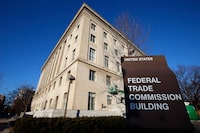 FILE - A sign stands outside the Federal Trade Commission building, Jan. 28, 2015, in Washington. The FTC is proposing sweeping changes to a decades-old law that regulates how online companies can track and advertise to children, including turning  off targeted ads to kids under 13 by default and limiting push notifications. (AP Photo/Alex Brandon, File)