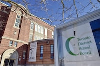 &nbsp;A Toronto District School Board logo is seen on a sign in front of a high school in Toronto, Tuesday, Jan. 30, 2018.&nbsp;An anti-racism trainer accused of denigrating a Toronto principal who later died by suicide says she welcomes the Ontario education minister's review.&nbsp;THE CANADIAN PRESS/Frank Gunn