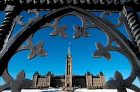 Centre Block is shown through the gates of Parliament Hill in Ottawa on Feb. 11, 2014. THE CANADIAN PRESS/Justin Tang