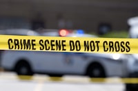 Police west of Toronto are looking for the driver and occupants of a light-coloured SUV that was seen driving away from the area where a 19-year-old woman was fatally shot outside a nightclub. Crime scene tape blocks off an area on July 13, 2021, in Baltimore, Md. THE CANADIAN PRESS/AP/Jose Luis Magana