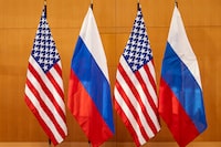 Russian and American flags displayed at the United States Mission prior top talks between deputy foreign minister Sergei Ryabkov and US Deputy Secretary of State Wendy Sherman in Geneva, Switzerland, on Monday, Jan. 10, 2022. (Denis Balibouse/Pool via AP)