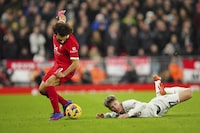 Liverpool's Mohamed Salah, left, and Manchester United's Alejandro Garnacho challenge for the ball during the English Premier League soccer match between Liverpool and Manchester United at the Anfield stadium in Liverpool, England, Sunday, Dec.17, 2023. (AP Photo/Jon Super)
