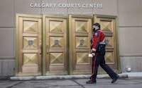 A 17-year-old Calgarian who was arrested as part of a national security investigation is to be prohibited from accessing social media and required to participate in an intervention plan that addresses ideological extremism. A police officer enters the Calgary Courts Centre in Calgary on Friday, Oct. 30, 2020. THE CANADIAN PRESS/Jeff McIntosh