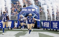Winnipeg Blue Bombers' Adam Bighill (4) runs out at the beginning of their CFL season opener against the Hamilton Tiger-Cats in Winnipeg Friday, June 9, 2023. Bighill is hoping Winnipeg Blue Bombers fans get at least one thing they want on Friday - a victory. THE CANADIAN PRESS/John Woods