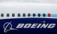 FILE PHOTO: The Boeing logo is seen on the side of a Boeing 737 MAX at the Farnborough International Airshow, in Farnborough, Britain, July 20, 2022.  REUTERS/Peter Cziborra/File Photo