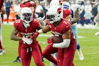 Arizona Cardinals linebacker Kyzir White (7) celebrates his interception against the Dallas Cowboys with Cardinals cornerback Kei'Trel Clark (13) during the second half of an NFL football game Sunday, Sept. 24, 2023, in Glendale, Ariz. The Cardinals won 28-16. (AP Photo/Ross D. Franklin)