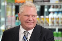 Ontario Premier Doug Ford attends a press availability at a convenience store in Toronto, Thursday, Dec. 14, 2023. The Ontario Government announced that in 2026 they will allow sales of beer, wine, cider, coolers and pre-mixed drinks to be sold at convenience stores, grocery stores and "big box" retailers. THE CANADIAN PRESS/Chris Young