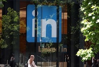 SAN FRANCISCO, CALIFORNIA - JULY 26: A pedestrian walks by a sign at a LinkedIn office on July 26, 2023 in San Francisco, California. LinkedIn announced plans to cut nearly 200 jobs at offices in the San Francisco Bay Area. The cuts follow 700 layoffs earlier in the year. (Photo by Justin Sullivan/Getty Images)