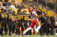Injuries last season limited the 6-1, 231-pound Simoni Lawrence to just nine regular-season games with the Hamilton Tiger-Cats. Lawrence (21) successfully defends agains a catch attempt by Calgary Stampeders running back Dedrick Mills (26) during first half CFL football game action in Hamilton, Ont., Saturday, Sept. 30, 2023. THE CANADIAN PRESS/Peter Power