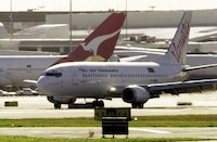 An Air Vanuatu plane makes an emergency landing at Sydney Airport, August 2, 2001, after suspected under carriage damage. Air Vanuatu announced on Thursday, May 9, 2024, the airline had cancelled international flights for four days and was considering bankruptcy protection for the South Pacific state-owned carrier. (Dean Lewins/AAP Image via AP)