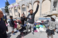 Migrants shout in front of the UNHCR headquarters in Tunis after the police dismantled a camp for refugees from sub-Saharan African countries, on April 11, 2023. (Photo by FETHI BELAID / AFP) (Photo by FETHI BELAID/AFP via Getty Images)