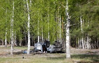 A view shows a damaged white Audi Q7 car lying overturned on a track next to a wood, after Russian nationalist writer Zakhar Prilepin was allegedly wounded in a bomb attack in a village in the Nizhny Novgorod region, Russia, May 6, 2023. REUTERS/Anastasia Makarycheva
