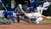 KANSAS CITY, MISSOURI - APRIL 22:  Adam Frazier #26 of the Kansas City Royals is tagged out by Danny Jansen #9 of the Toronto Blue Jays as he tries to score in the seventh inning at Kauffman Stadium on April 22, 2024 in Kansas City, Missouri. (Photo by Ed Zurga/Getty Images)
