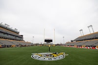 Hamilton Tiger-Cats teammates take part in a practice at Tim Hortons Field during the CFL's Grey Cup week in Hamilton, Friday, December 10, 2021. The Hamilton Tiger-Cats will play the Winnipeg Blue Bombers in the 108th Grey Cup on Sunday. THE CANADIAN PRESS/Nick Iwanyshyn