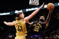 Los Angeles Lakers forward LeBron James (23) shoots around Toronto Raptors forward Kelly Olynyk (41) during second half NBA basketball action in Toronto on Tuesday, April 2, 2024. THE CANADIAN PRESS/Frank Gunn