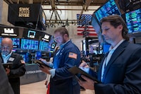 Traders walk the floor during morning trading at the New York Stock Exchange (NYSE) on May 14.