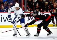 Toronto Maple Leafs centre Auston Matthews (34) passes the puck past Ottawa Senators right wing Drake Batherson (19) during first period NHL hockey action in Ottawa, on Saturday, April 1, 2023. THE CANADIAN PRESS/Justin Tang