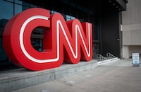 FILE - The CNN logo is displayed at the entrance to the CNN Center in Atlanta on Feb. 2, 2022. On Friday, May 12, 2023, The Associated Press reported on stories circulating online incorrectly claiming CNN cut short its primetime town hall with former President Donald Trump on Wednesday. (AP Photo/Ron Harris, File)
