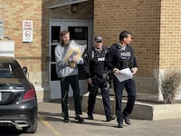Travis Patron, left, is seen leaving the courthouse after his sentence at Court of King’s Bench in Estevan, Sask., Thursday, Oct. 20, 2022. THE CANADIAN PRESS/Mickey Djuric