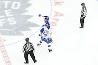 Linesmen watch as Tampa Bay Lightning's Tanner Jeannot fights Toronto Maple Leafs' Ryan Reaves during third period NHL hockey action in Toronto, on Wednesday, April 3, 2024.THE CANADIAN PRESS/Chris Young