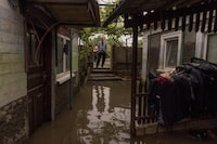 A man looks at his flooded house as the result of the Kakhovka dam destruction on June 12 in Afanasiivka village, Mykolaiv region, Ukraine.