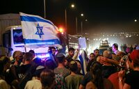 Protesters gather overnight in Tel Arad to block aid trucks from travelling to Jordan.
April 24,  2024
(Nathan VanderKlippe/The Globe and Mail)