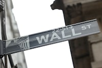 FILE PHOTO: A street sign marks Wall Street outside the New York Stock Exchange (NYSE) in New York City, where markets roiled after Russia continues to attack Ukraine, in New York, U.S., February 24, 2022.   REUTERS/Caitlin Ochs/File Photo