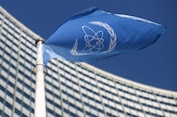 FILE PHOTO: A flag with the logo of the International Atomic Energy Agency (IAEA) waves in front of the IAEA headquarters, amid the coronavirus disease (COVID-19) outbreak in Vienna, Austria, March 1, 2021. REUTERS/Lisi Niesner
