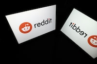 A picture taken on October 5, 2021 in Toulouse shows the logo of Reddit social media displayed by a tablet.