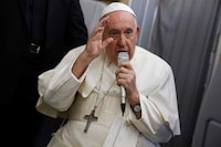 Pope Francis speaks during a news conference aboard the papal plane on his flight back after visiting Canada, July 29, 2022. - Pope Francis ended his six-day trip to Canada on July 29, 2022 as he began with a historic apology for the harm done to the country's indigenous people, again expressing his "outrage and shame" to Inuit in the Arctic. (Photo by GUGLIELMO MANGIAPANE / POOL / AFP) (Photo by GUGLIELMO MANGIAPANE/POOL/AFP via Getty Images)