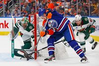 Feb 23, 2024; Edmonton, Alberta, CAN; Edmonton Oilers forward Corey Perry (90) tries to jame a shot past Minnesota Wild goaltender Filip Gustavsson (32) during the first period at Rogers Place. Mandatory Credit: Perry Nelson-USA TODAY Sports