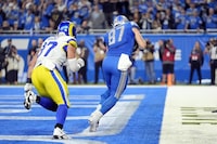 Detroit Lions tight end Sam LaPorta (87), defended by Los Angeles Rams linebacker Michael Hoecht (97), catches a 2-yard pass for a touchdown during the first half of an NFL wild-card playoff football game, Sunday, Jan. 14, 2024, in Detroit. (AP Photo/Paul Sancya)