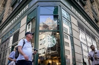 Pedestrians pass a Starbucks in the Financial District of Lower Manhattan, Tuesday, June 13 in New York.