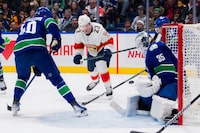 Dec 14, 2023; Vancouver, British Columbia, CAN; Vancouver Canucks forward Elias Pettersson (40) watches as goalie Thatcher Demko (35) makes a save on Florida Panthers forward Carter Verhaeghe (23) in the first period at Rogers Arena. Mandatory Credit: Bob Frid-USA TODAY Sports