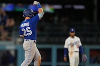 Toronto Blue Jays' Daulton Varsho celebrates after driving in two-runs with a bases-loaded double during the 11th inning of a baseball game against the Los Angeles Dodgers Monday, July 24, 2023, in Los Angeles. (AP Photo/Marcio Jose Sanchez)