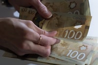Some people may have a disconnect between understanding their debts and managing their finances to pay off the loans, a survey by Chartered Professional Accountants of Canada shows. Canadian $100 bills are counted in Toronto, Feb. 2, 2016. THE CANADIAN PRESS/Graeme Roy