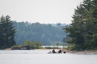 Canadian Armed Forces (CAF) conduct searches around a series of islands on the Ottawa River near Fort William in the Pontiac Regional County Municipality on Tuesday, June 20, 2023. The Canadian Armed Forces says it plans to pull the CH-147H Chinook helicopter that crashed into the Ottawa river last month out of the water today. THE CANADIAN PRESS/Spencer Colby