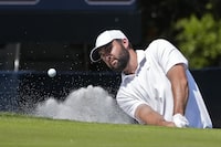 Scottie Scheffler hits out of the sand on the second green during the final round of The Players Championship golf tournament Sunday, March 17, 2024, in Ponte Vedra Beach, Fla. (AP Photo/Marta Lavandier)