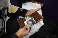 Hank Nowak holds his wallet that was lost with his I.D. cards and a photo of his father, at the McCormick rink in Toronto, Friday Dec. 1, 2023. (Christopher Katsarov/The Globe and Mail)
