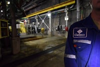 Cameco Corp. reported a loss in its latest quarter as it was hit by charges related to its acquisition of a stake in Westinghouse Electric Co., one of the world's largest nuclear services businesses. A Cameco employee  is shown during a media tour of the uranium mine in Cigar Lake, Sask. on Wednesday, Sept. 23, 2015. THE CANADIAN PRESS/Liam Richards