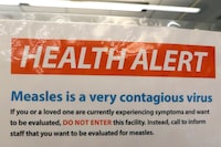 Toronto Public Health says it is investigating the second lab-confirmed measles case in Toronto this year. A notice for a health alert about measles is posted on the door of a medical facility in Seattle on Wednesday, Feb. 13, 2019. THE CANADIAN PRESS/AP/Elaine Thompson