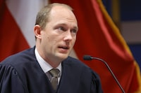 FILE- Fulton County Superior Judge Scott McAfee presides over a hearing is to determine whether Fulton County District Attorney Fani Willis should be removed from the case because of a relationship with Nathan Wade, special prosecutor she hired in the election interference case against former President Donald Trump, Friday, March, 1, 2024, in Atlanta. Scott McAfee, who's presiding over the election interference case, drew two challengers Friday, March 8, 2024, for his nonpartisan race in May: civil rights attorney Robert Patillo and Tiffani Johnson, a staff attorney for another Fulton County judge. (AP Photo/Alex Slitz, Pool, File)