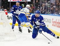 Toronto Maple Leafs forward Auston Matthews (34) controls the puck as he stumbles against the Buffalo Sabres during first period NHL hockey action in Toronto on Wednesday, March 6, 2024. THE CANADIAN PRESS/Nathan Denette