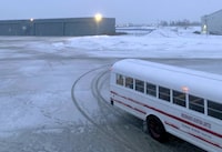 This image provided by Nathan Johnson shows the buses used to transport passengers to military barracks in Goose Bay, Canada, on Monday, Dec. 11, 2023, where passengers aboard a Delta Air Lines flight from Amsterdam to Detroit spent the night after the plane was forced to land due to a mechanical issue. (Nathan Johnson via AP)