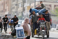 People ride on a vehicle loaded with belongings, as Palestinians prepare to evacuate, after Israeli forces launched a ground and air operation in the eastern part of Rafah, amid the ongoing conflict between Israel and Hamas, in Rafah, in the southern Gaza Strip, May 11, 2024. REUTERS/Hatem Khaled