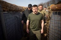 In this photo provided by the Ukrainian Presidential Press Office, Ukrainian President Volodymyr Zelenskyy inspects the fortification lines in Kharkiv region, Ukraine, Tuesday, April 9, 2024. (Ukrainian Presidential Press Office via AP)