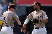 San Diego Padres second baseman Xander Bogaerts, right, celebrates with teammate first baseman Jake Cronenworth after the Padres defeated the Toronto Blue Jays 6-3 in a baseball game, Sunday, April 21, 2024, in San Diego. (AP Photo/Gregory Bull)